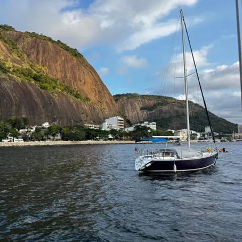 A sailing boat moored below the Rio hills