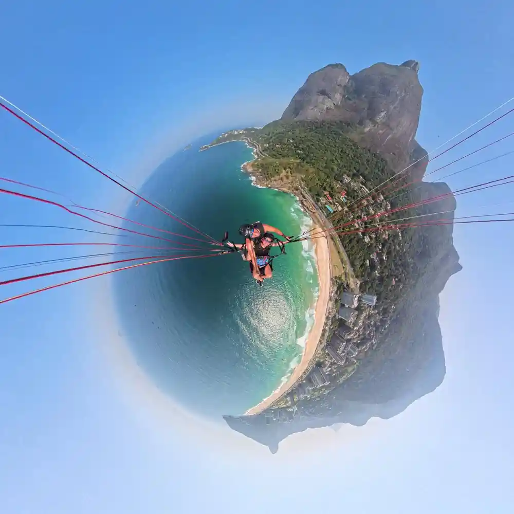 The coastline curved into a small planet below the wing