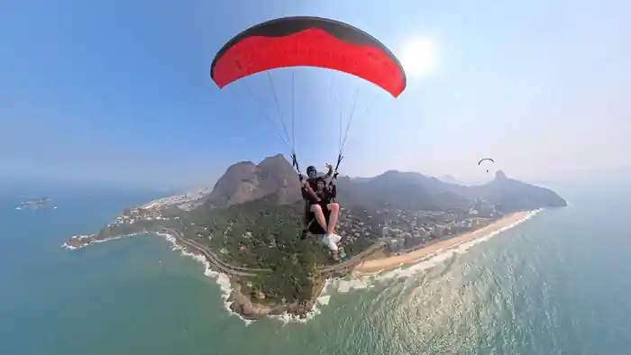A red wing above the headland and the beach
