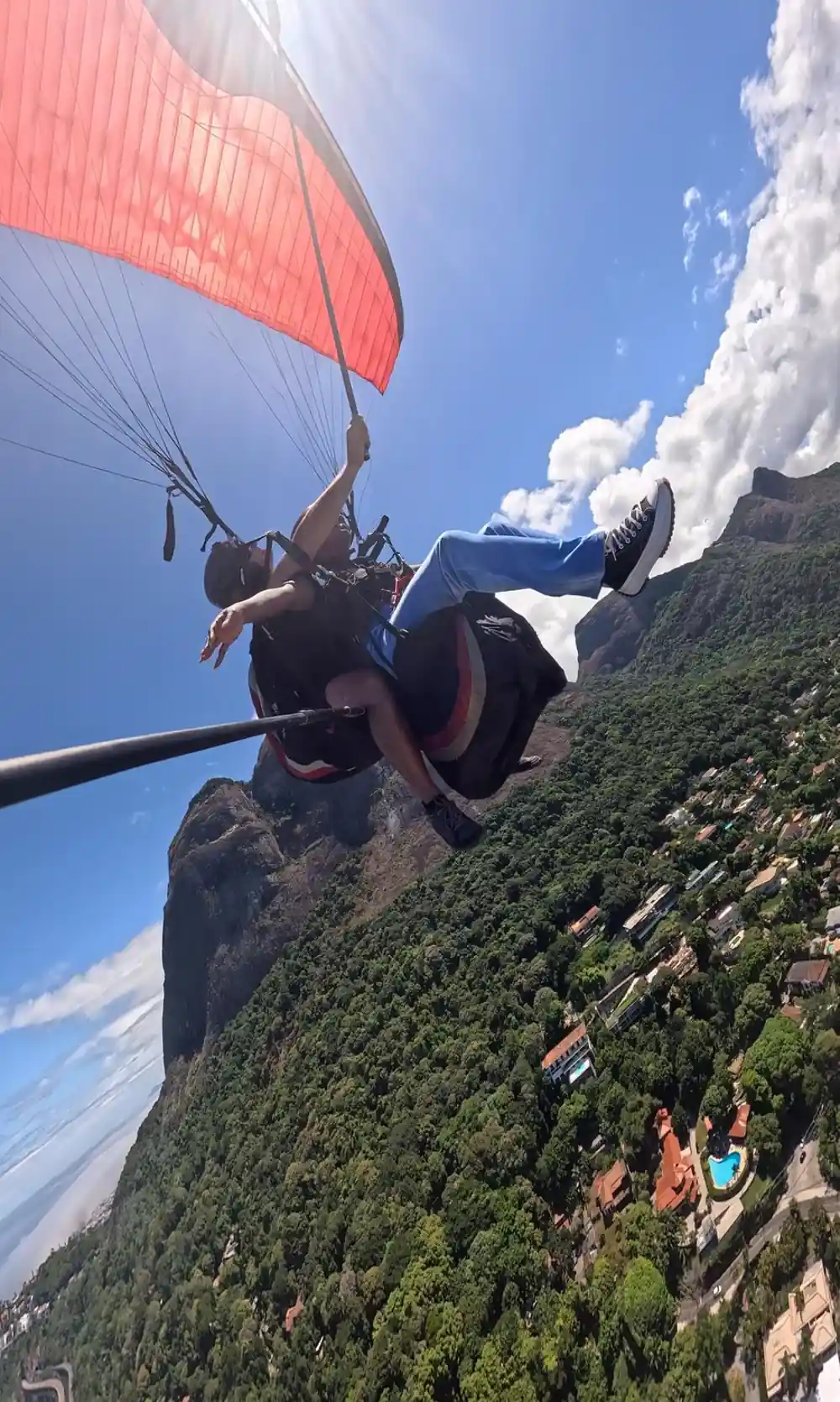 A tandem climbing past cloud beside the ridge