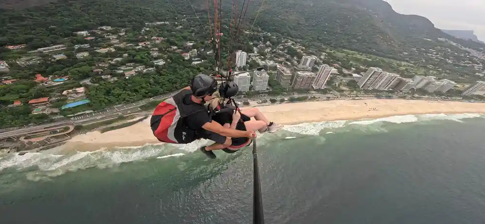 A tandem tracking along the beach below the towers