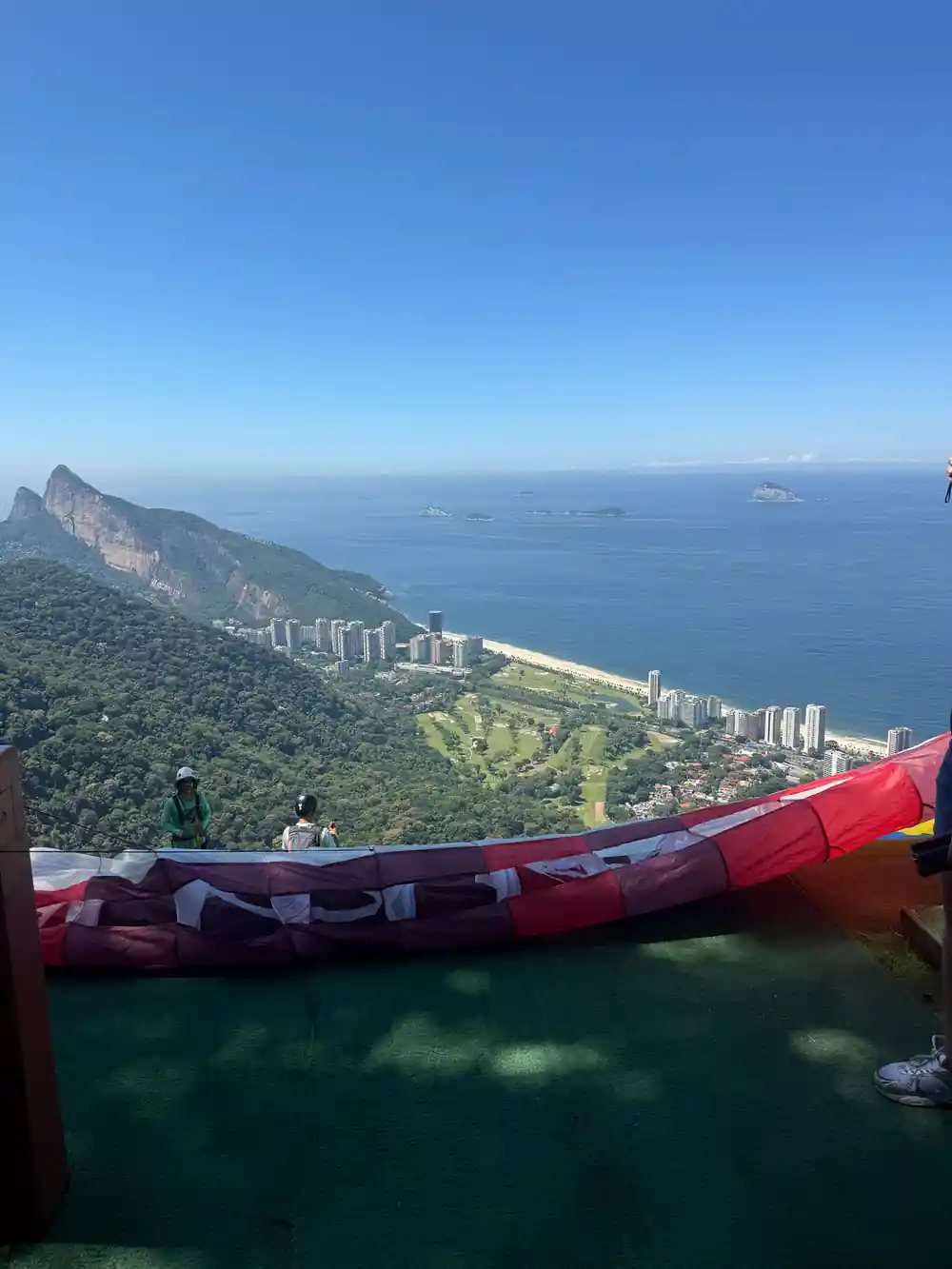 A wing spread on the ramp above the beach and the mountain